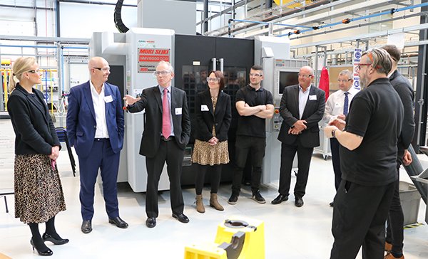 Representatives from Close Brothers Group plc, pictured alongside University of Sheffield AMRC Training Centre apprentice alumni touring the training centre workshop.